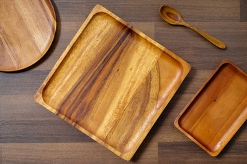 Empty wooden tray and spoon on table