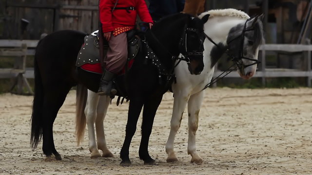 The Middle Ages. Envoys horse riders reading aloud a royal decree to villagers