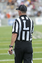 College Football referees and judges manage a game