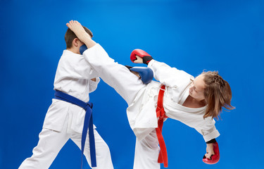 With overlays on the hands of the athletes are training blows karate