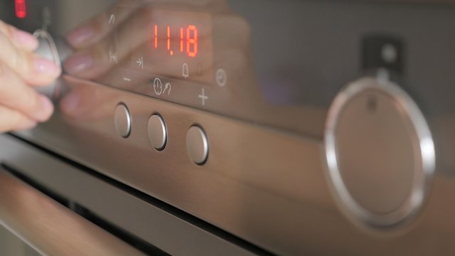 Selective focus on  modern oven  buttons while programing for cooking 4K 2160p UltraHD footage - Cooking contemporary  oven setting dials for temperature and program 4K 3840X2160 UHD video