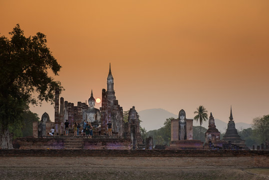 Ancient Buddha Statue at sunset Sukhothai historical park, Mahathat Temple ,Thailand.