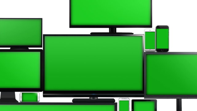 Many different types of screens. TVs, computer monitors, smartphones and tablets. They laid on each other in a pile isolated on a white background. They are all with a green screen. Zoom in..
