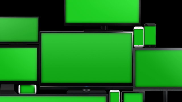 Many different types of screens. TVs, computer monitors, smartphones and tablets. They laid on each other in a pile isolated on a white background. They are all with a green screen. Zoom in & alpha