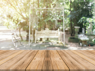 Wooden board empty table in front of blurred background. Perspective brown wood over blur trees in forest - can be used mock up for display or montage your products. spring season. vintage filtered.