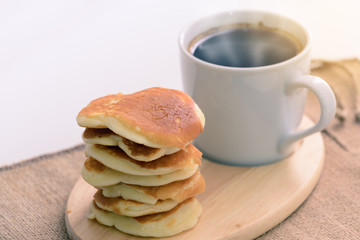 Kanom Babin, Thai dessert made from rice and coconut, hot coffee background.