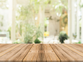 Wooden board empty table in front of blurred background. Perspective brown wood over blur in coffee...