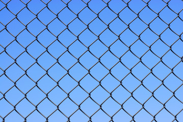 Fototapeta na wymiar iron net fence against blue sky