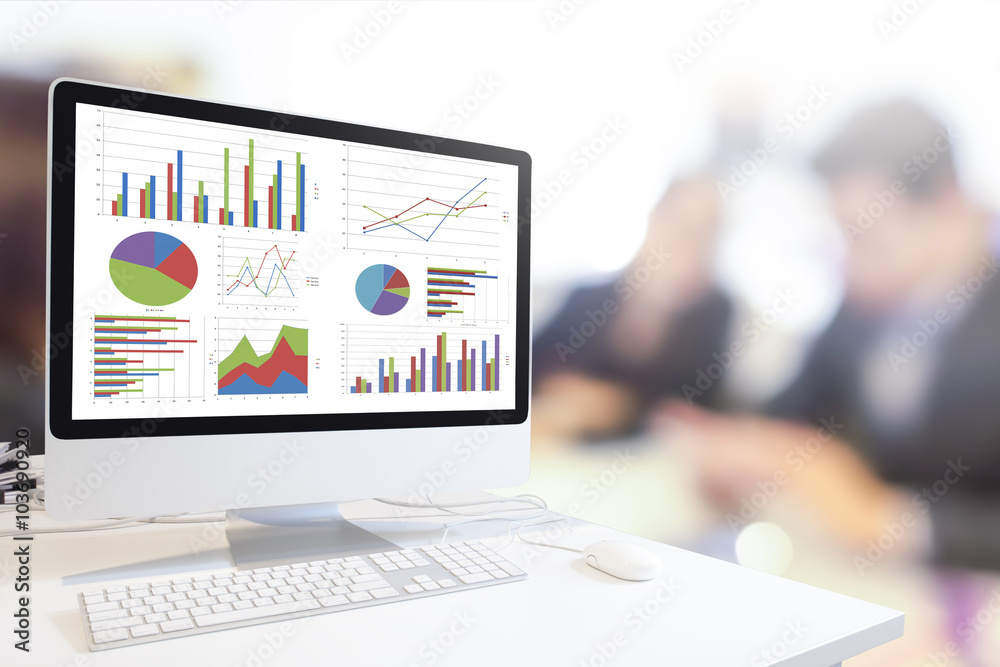 Wall mural modern computer with keyboard and mouse on table showing charts