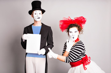 Two mimes with a sign for advertising