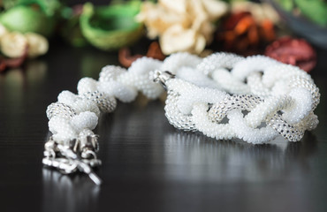 Handmade necklace of white beads in the form of braid