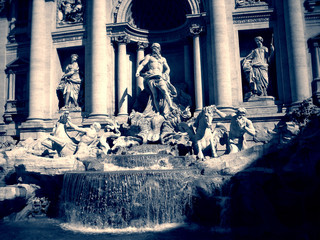 Trevi Fountain in Rome on a sunny day, in black and white. Monochrome image filtered in faded, vintage style with red filter and soft focus; nostalgic concept of travel.