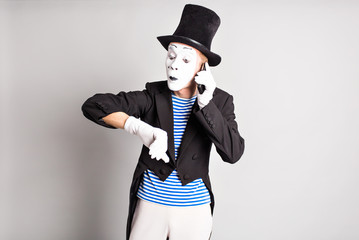 Business and time management concept. Stressed man  looking at wrist watch, running late for meeting