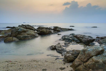 Fototapeta na wymiar smoke sea rock with twiilight sky