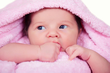 Newborn baby  girl on a soft pink terry towel