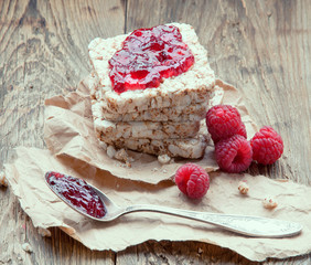 Breakfast.Slices of cereal with raspberries and jam.