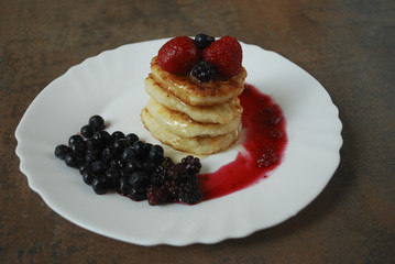 Dessert: cheese pancakes with berries (strawberries, blackberries, blueberries).
