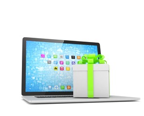 Gift box with ribbon bow on laptop keyboard