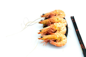 Boiled shrimp and black plate on white background
