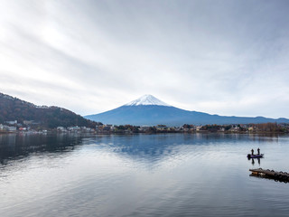 Fuji mountain under cloudy sky with lake