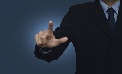 Businessman pointing to something or touching a touch screen on