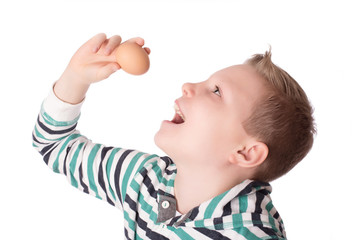Young boy play the eggs over the white