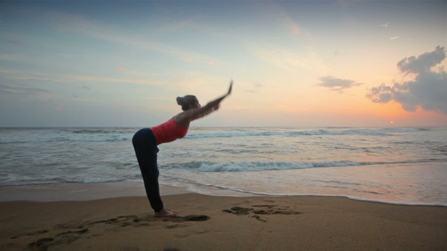 Woman doing yoga Sun Salutation Surya Namaskar