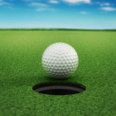 Golf ball standing near the hole