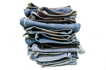 Stack blue jeans on white background. 
