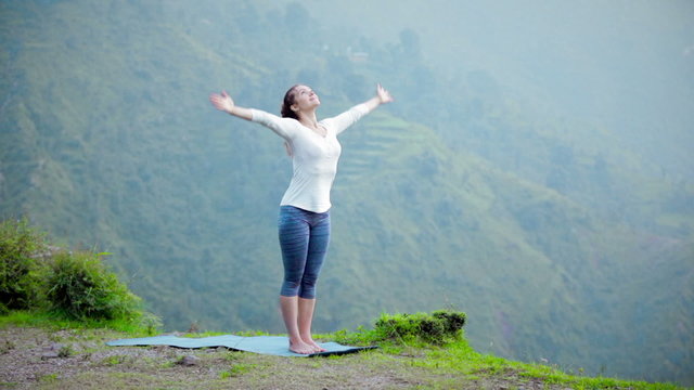 Woman doing yoga Sun Salutation Surya Namaskar