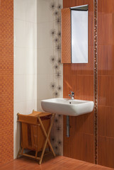 detail of modern private bathroom interior in orange