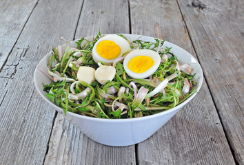 Dandelion salad with eggs and garlic