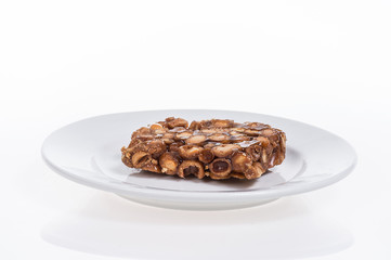 peanut candy on the plate isolated on white background