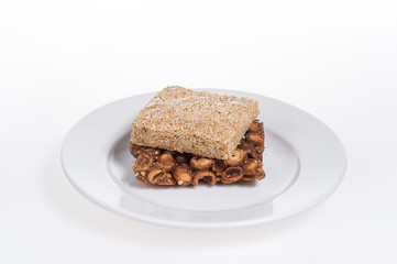 peanut candy on the plate isolated on white background
