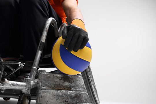 Niepełnosprawny na w&oacute;zku inwalidzkim.Mężczyzna na sportowym w&oacute;zku  inwalidzkim z piłką 