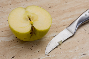 Knife and green sweet delicious sliced apple