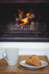 View of coffee and croissant on a table