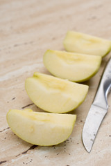 Slices of green sweet apple and metal knife