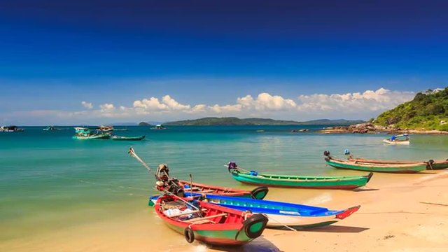 Camera Moves to Tourist Boats at Beach against Island in Vietnam