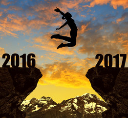 Girl jumps to the New Year 2017 at sunset.