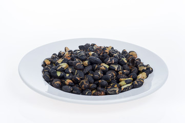 Fototapeta na wymiar Black beans on white plate isolated on white background 