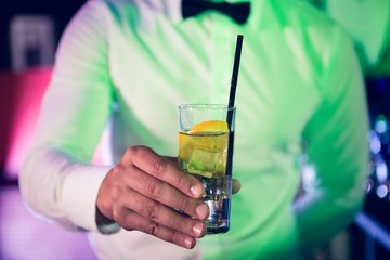 Bartender serving glass of gin