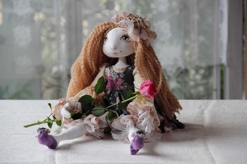 Doll with long hair and a rose