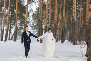 couple newlyweds walking in a winter forest