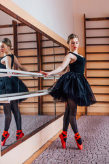 Young Smiling Ballerina Wearing white Tutu Doing exercise in training  hall. Series of photo.