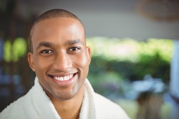 Smiling man in bath robe drinking coffee