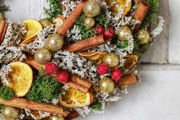 Christmas door wreath with cinnamon sticks and dried oranges