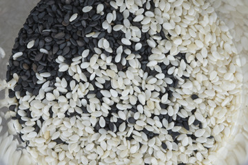 Black sesame and white sesame in bottle,shot on top ,background
