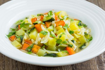 Vegetable minestrone with orzo pasta, zucchini, capsicum, potato