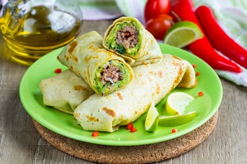 Pancakes stuffed with avocado sauce, meat beef kebab, Mexican 